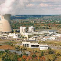 An image of a nuclear power plant among autumn trees.