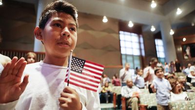 New U.S. citizen Davies Garcia, 11, originally from Mexico, holds an American flag during a naturalization ceremony conducted by U.S. Citizenship and Immigration Services (USCIS), on September 14, 2018 in Los Angeles, California. boy child immigrant