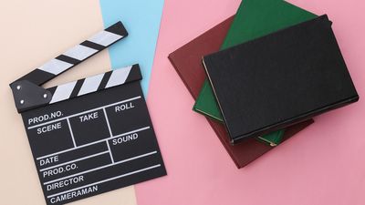 For a quiz about books/film adaptations. Clapper board and books or scripts. cinema, movies, motion pictures, clapboard, hollywood