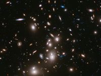 Bright lights scattered against a dark background. Some are round and bright. Others are small and dim.