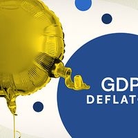 Gold balloon that is deflating from a valve. A large blue circle with white text reads "GDP DEFLATOR," surrounded by smaller blue circles on a light background.