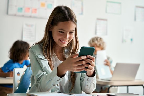 A girl on her cell phone in class