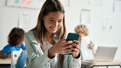 A girl on her cell phone in class
