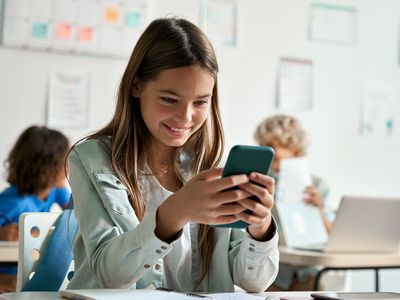 A girl on her cell phone in class