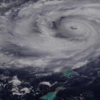 How are hurricanes and typhoons named?