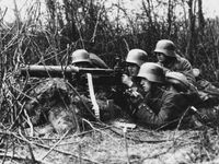 Figure 13: A Maxim machine gun, belt-fed and water-cooled, operated by German infantrymen, World War I.