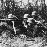 Figure 13: A Maxim machine gun, belt-fed and water-cooled, operated by German infantrymen, World War I.