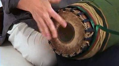 Watch and hear a person playing the mridangam drum of the Carnatic music tradition