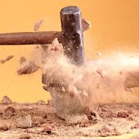 Sledgehammer breaking rocks