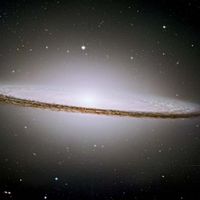 The Sombrero Galaxy (M104) is a normal spiral galaxy in the constellation Virgo. It appears nearly edge-on in an image captured by the Hubble Space Telescope.