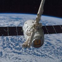 The SpaceX Dragon capsule being grappled by the International Space Station's Canadarm2 robotic arm, 2012.