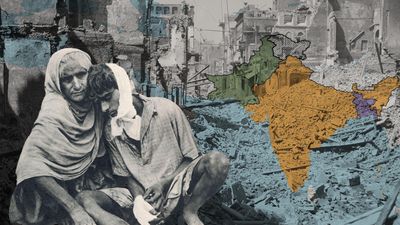 Two distressed people sit amid ruins; behind them is a partitioned, color-coded map of India overlaid on destroyed urban buildings.