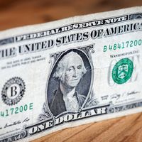 A photograph of a U.S. one dollar bill featuring George Washington's portrait.