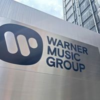 An outdoor Warner Music Group plaque on a sign located in the exterior courtyard of the Paramount Plaza building, where WMG is headquartered, 1633 Broadway, New York.